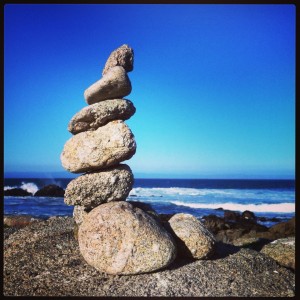 rock cairn with ocean backdrop