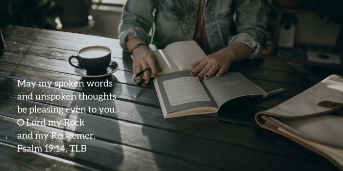 Woman sitting at a table with a journal and a cup of coffee with quotation of Psalm 19:14, TLB